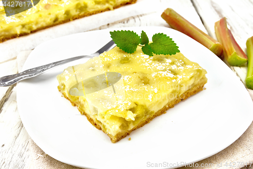 Image of Kukhen with rhubarb and pudding in plate on wooden board