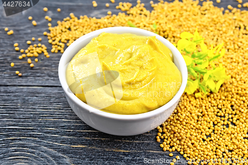 Image of Sauce mustard in bowl with flower on board