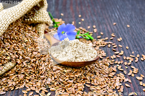 Image of Flour flax in spoon with flower on board