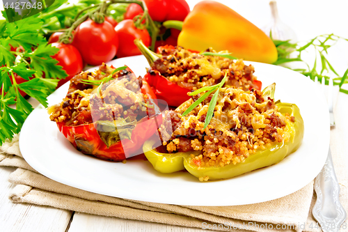 Image of Pepper stuffed with meat and couscous in plate on table