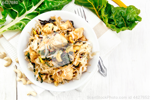 Image of Funchoza with chard and cashew in bowl on board top