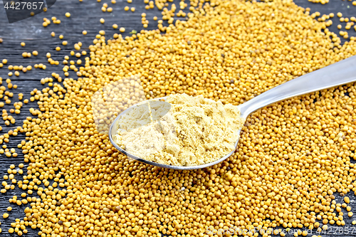 Image of Mustard powder in spoon on board