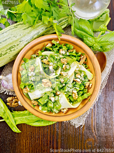 Image of Salad with squash and sorrel on dark board top