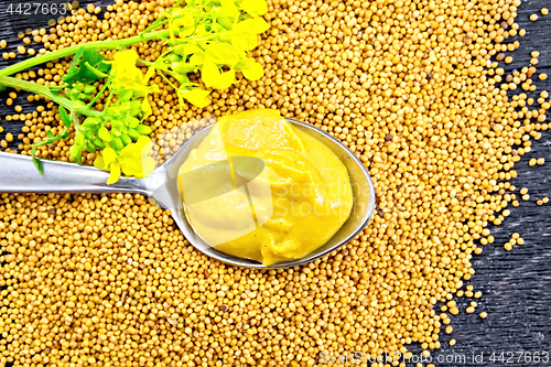 Image of Sauce mustard in spoon with flower on board top