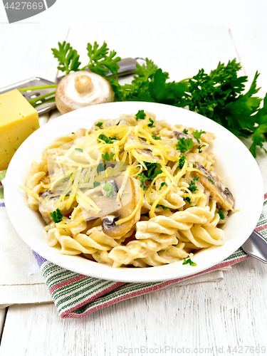 Image of Fusilli with mushrooms and cream on light board