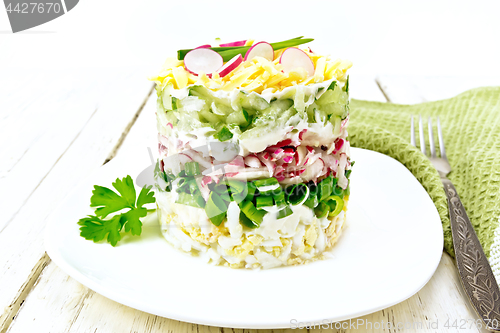 Image of Salad layered with radish and cucumber in plate on board