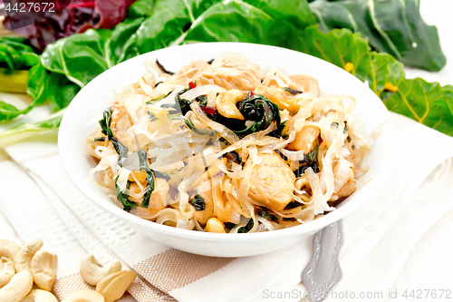 Image of Funchoza with chard and cashew in bowl on light board