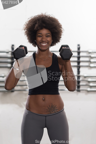 Image of black woman doing bicep curls