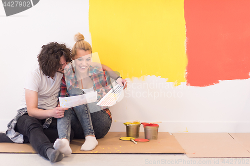 Image of Happy young couple relaxing after painting