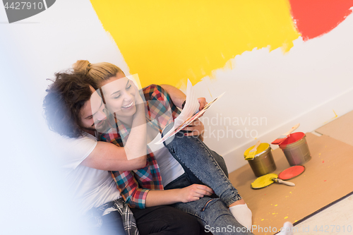 Image of Happy young couple relaxing after painting