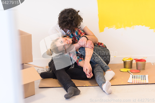 Image of Happy young couple relaxing after painting