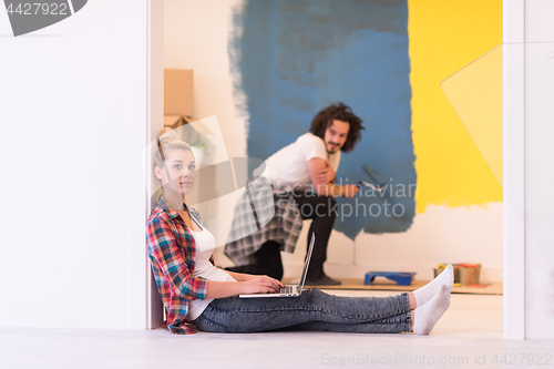 Image of Happy couple doing home renovations