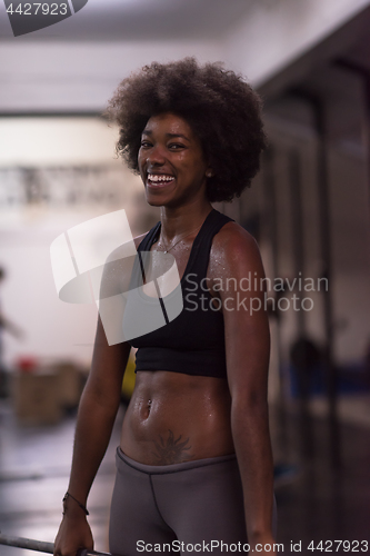 Image of black woman lifting empty bar