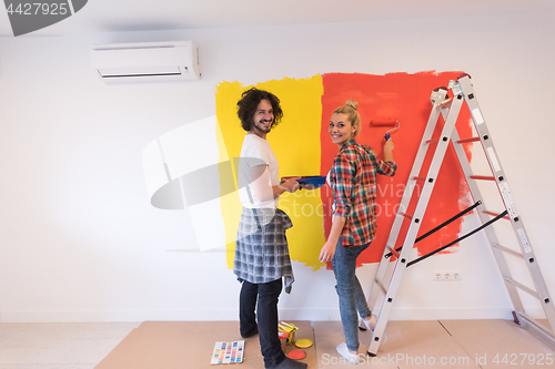 Image of couple painting interior wall