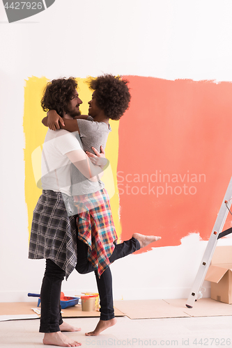 Image of Young happy multiethnic couple hugging