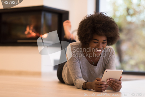 Image of black women using tablet computer on the floor