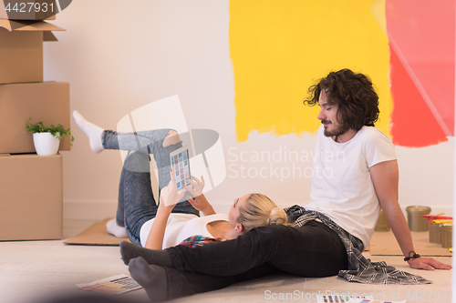Image of Happy young couple relaxing after painting