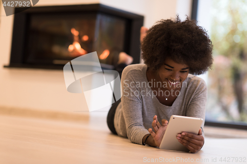 Image of black women using tablet computer on the floor