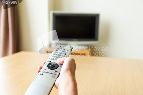 Image of TV remote control in hand