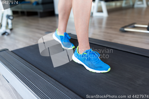 Image of Woman running on the treadmill at the gym