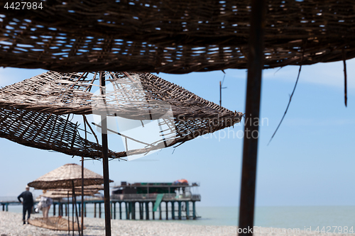 Image of Old sunshade with hole on beach 