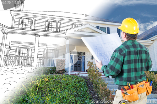 Image of Male Contractor with Hard Hat and Tool Belt Looking At Custom Ho