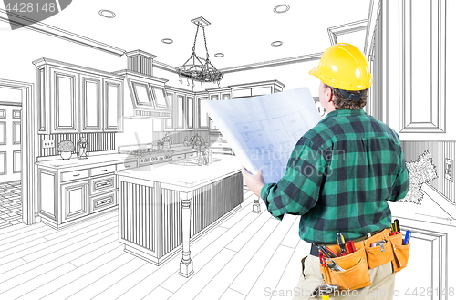 Image of Male Contractor with Hard Hat and Plans Looking At Custom Kitche