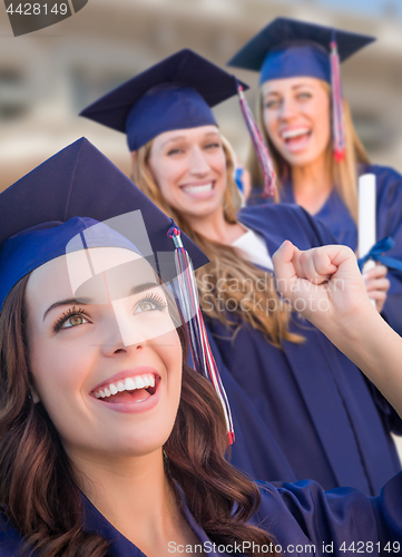 Image of Happy Graduating Group of Girls In Cap and Gown Celebrating on C