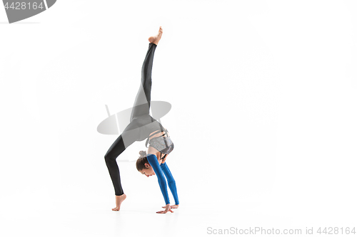 Image of young sporty woman doing acrobatic exercise