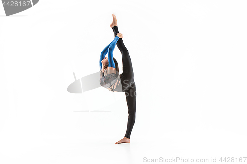 Image of young sporty woman doing acrobatic exercise