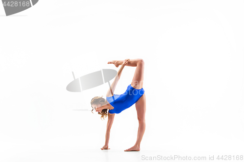 Image of young sporty woman doing acrobatic exercise