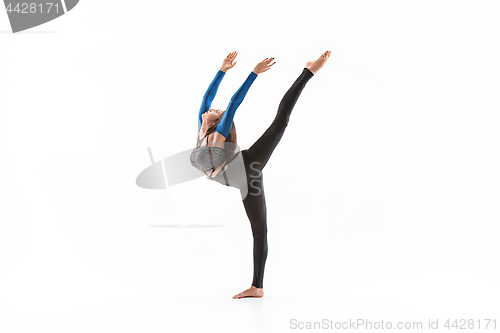 Image of young sporty woman doing acrobatic exercise