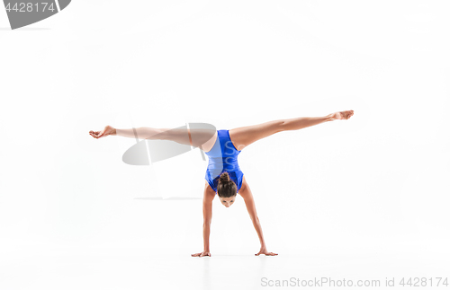 Image of young sporty woman doing acrobatic exercise