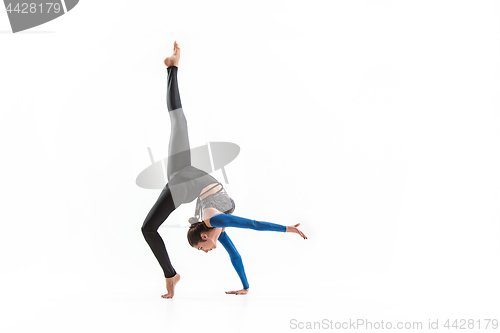 Image of young sporty woman doing acrobatic exercise