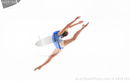 Image of young sporty woman doing acrobatic exercise