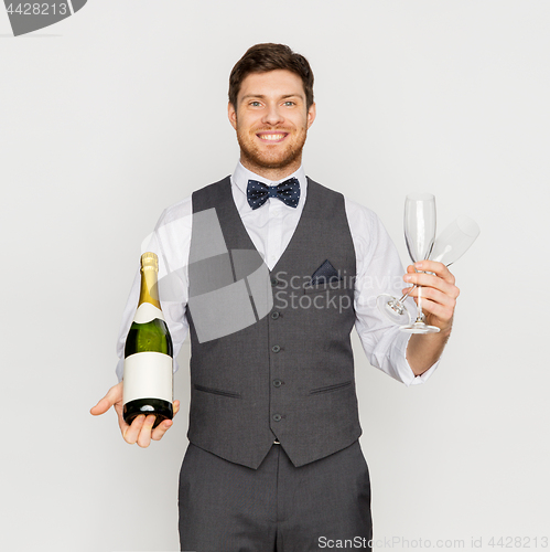 Image of man with bottle of champagne and glasses at party