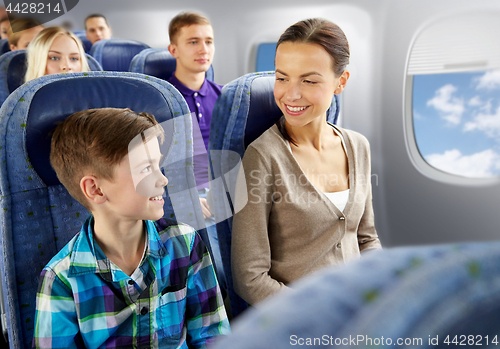 Image of happy mother and son traveling by plane