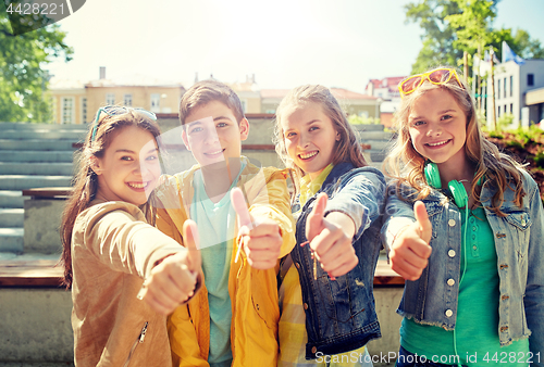 Image of happy students or friends showing thumbs up