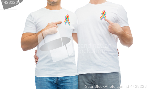 Image of close up of couple with gay pride rainbow ribbons