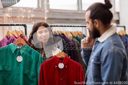 Image of couple choosing clothes at vintage clothing store