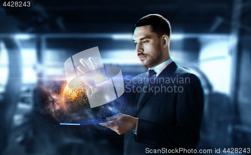 Image of businessman with transparent tablet and planet