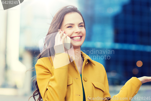 Image of smiling young woman or girl calling on smartphone