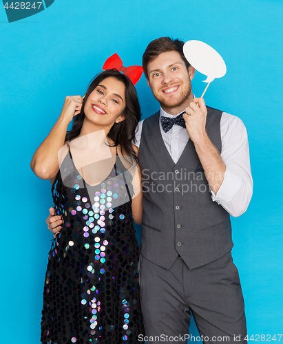 Image of happy couple with party props having fun