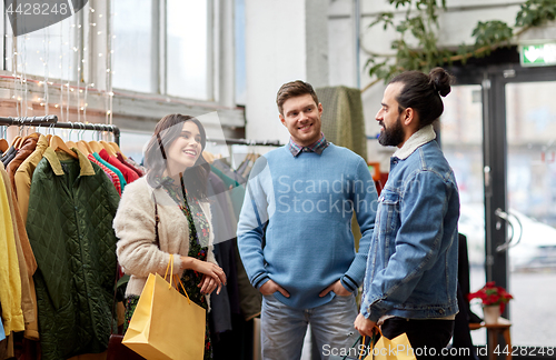 Image of friends shopping bags at vintage clothing store