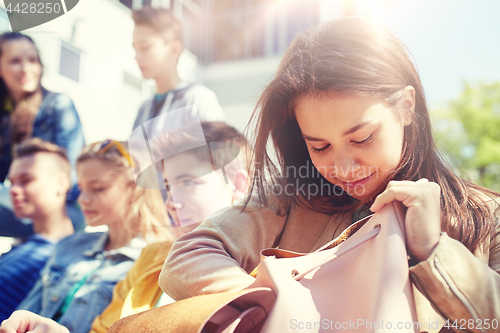 Image of high school student girl with backpack outdoors