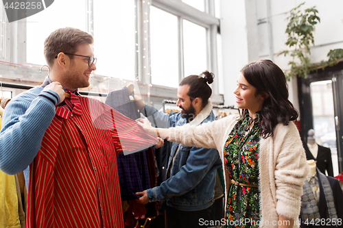 Image of friends choosing clothes at vintage clothing store