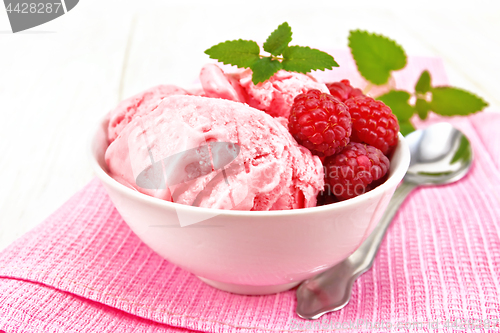 Image of Ice cream crimson with mint in bowl on board