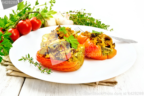 Image of Pepper stuffed with mushrooms and couscous in plate on table