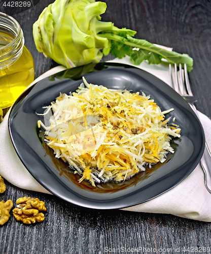 Image of Salad of carrot and kohlrabi with honey in plate on dark board