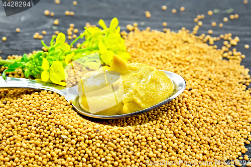 Image of Sauce mustard in spoon with flower on board